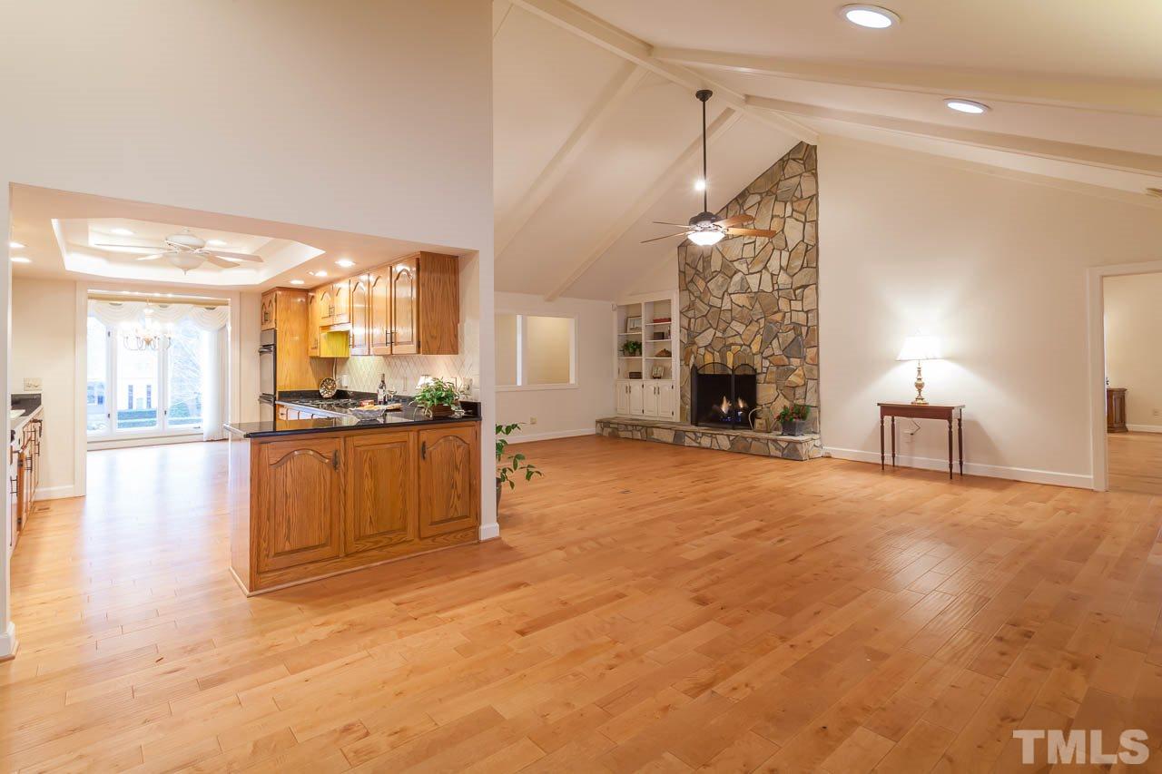 6909 Valley Ridge Court Raleigh, NC 27615 - Photo 10 of 25 a view of a living room a fireplace with cabinets and wooden floor