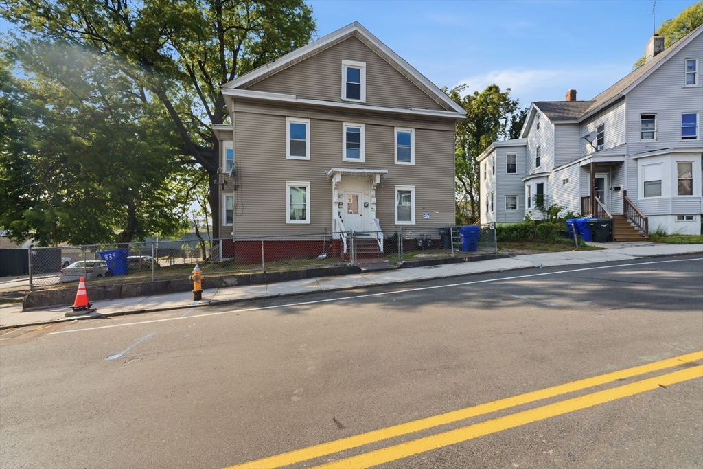 a front view of a house with a street