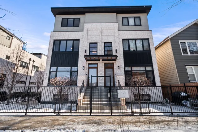 a front view of a house with iron stairs