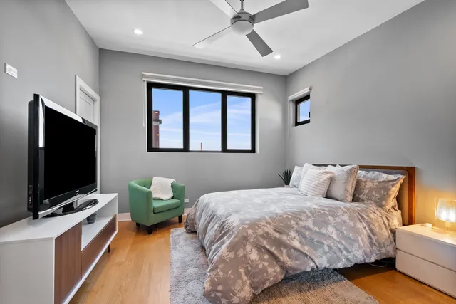 a bedroom with a bed and a flat screen tv