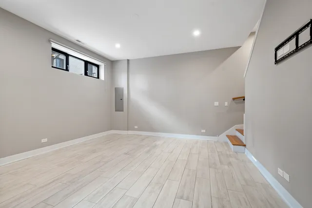 a view of empty room with wooden floor