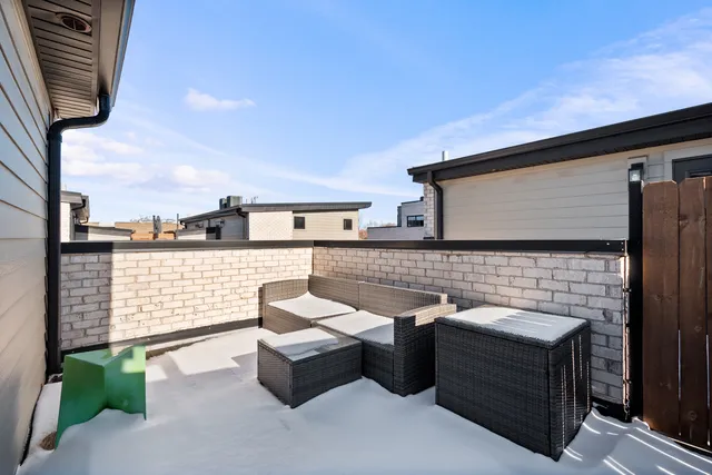 a terrace of a house with outdoor seating