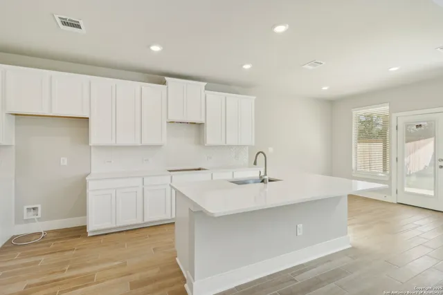 a kitchen with white cabinets and white appliances