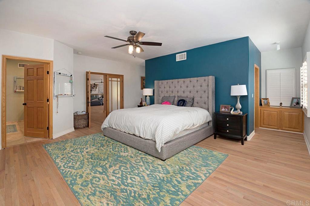 3743 Via Cielo Azul Alpine, CA 91901 - Photo 17 of 34 a bedroom with a bed and a chandelier