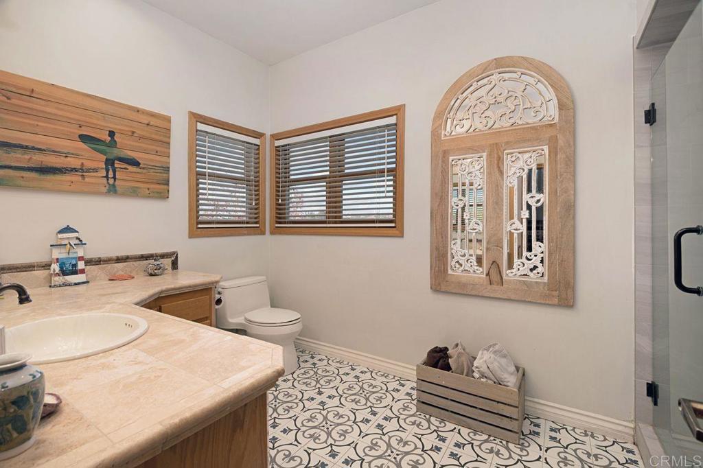 3743 Via Cielo Azul Alpine, CA 91901 - Photo 24 of 34 a bathroom with a granite countertop toilet sink and mirror