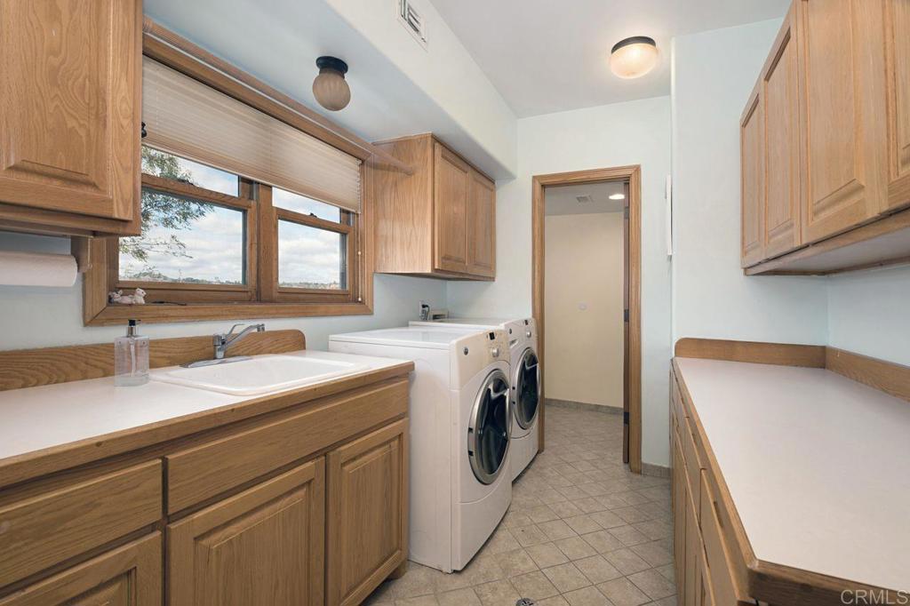 3743 Via Cielo Azul Alpine, CA 91901 - Photo 25 of 34 a utility room with cabinets washer and dryer