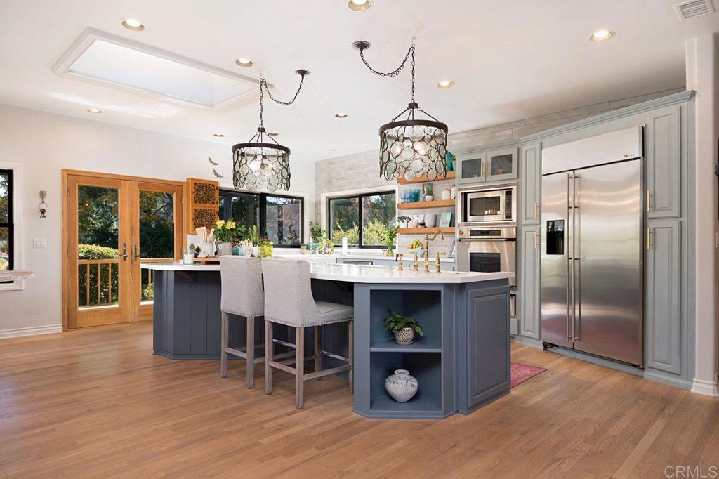 3743 Via Cielo Azul Alpine, CA 91901 - Photo 10 of 34 a view of a dining room and livingroom with furniture wooden floor a chandelier