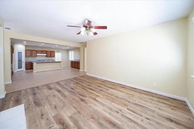 a kitchen with stainless steel appliances kitchen island granite countertop a refrigerator and a stove top oven