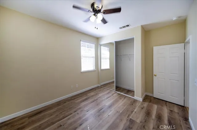 a view of a room with wooden floor and windows