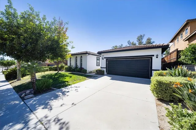 a front view of a house with a yard and a garage