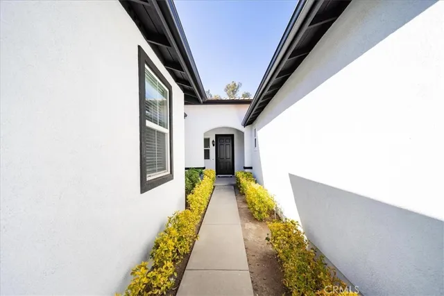 a hallway with painted walls and a black white checkered floor