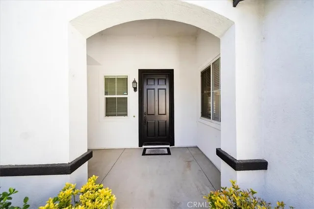 an empty room with windows and entrance