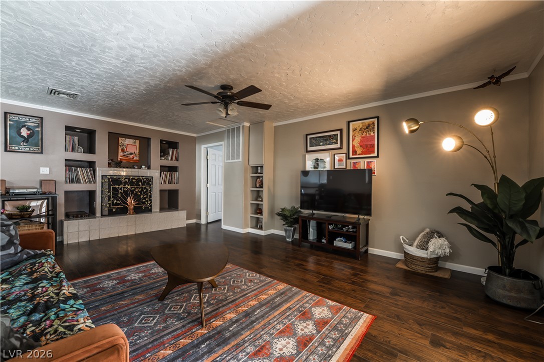 1324 Appaloosa Road Boulder City, NV 89005 - Photo 14 of 42 Rich hardwood floors complement a statement fireplace, setting a warm and inviting atmosphere.