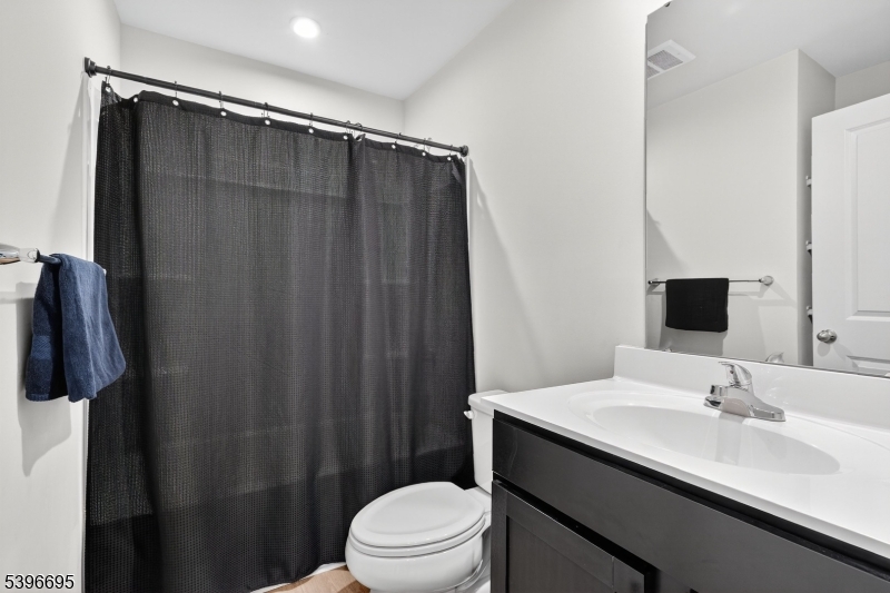 55 Limestone Boulevard Washington, NJ 07882 - Photo 19 of 24 a bathroom with a sink a toilet a shower and a mirror