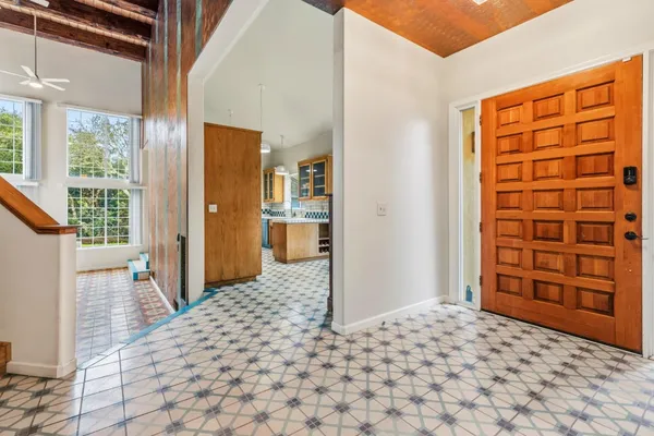 a bedroom with a bed and wooden cabinets
