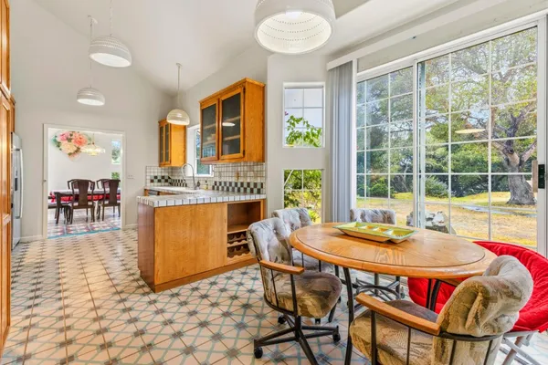 a dining room with furniture and wooden floor