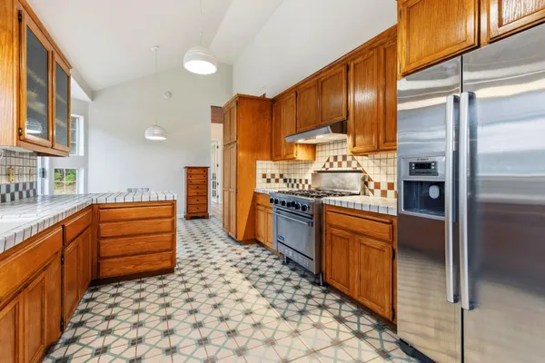 a kitchen with stainless steel appliances and cabinets