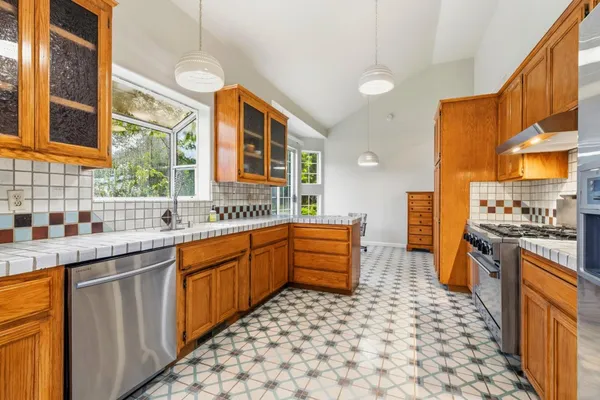 a kitchen with stainless steel appliances a sink stove and refrigerator
