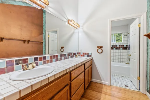 a bathroom with a sink a mirror and a shower