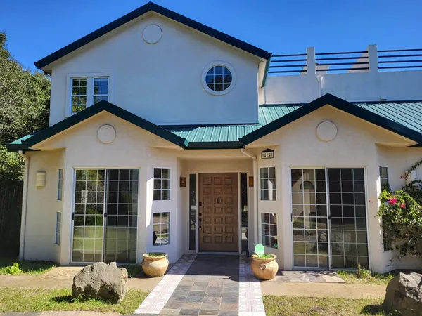 a front view of a house with garden