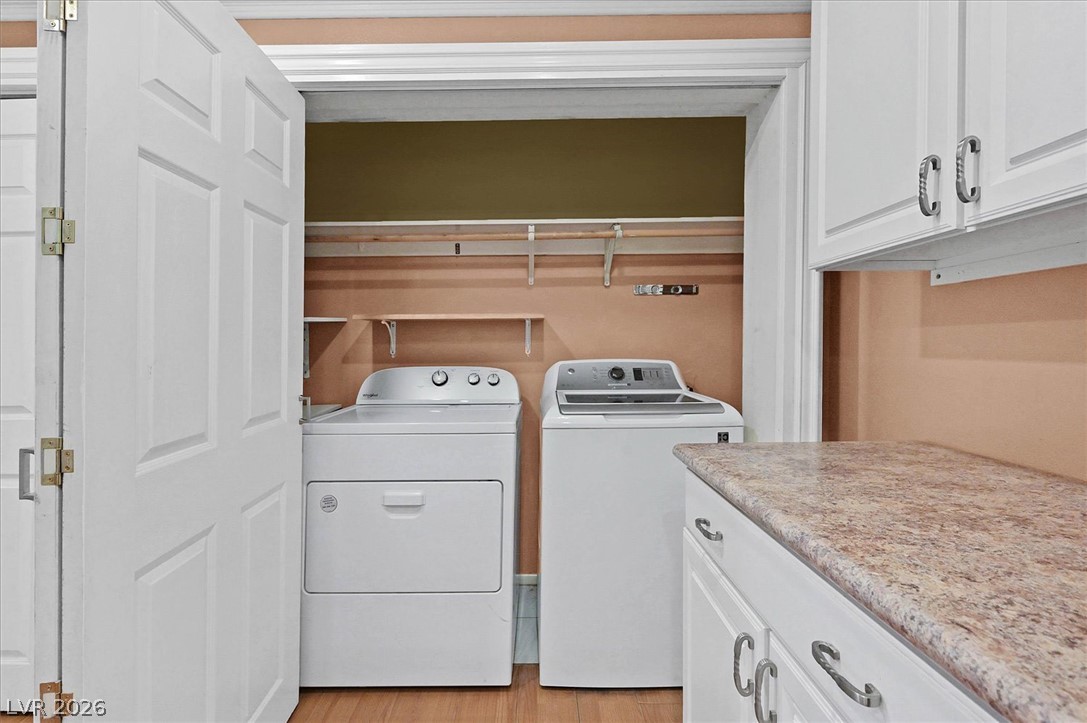 3618 Fieldcrest Road Las Vegas, NV 89121 - Photo 28 of 36 Functional laundry space featuring a washer and dryer, with convenient shelving and countertop.
