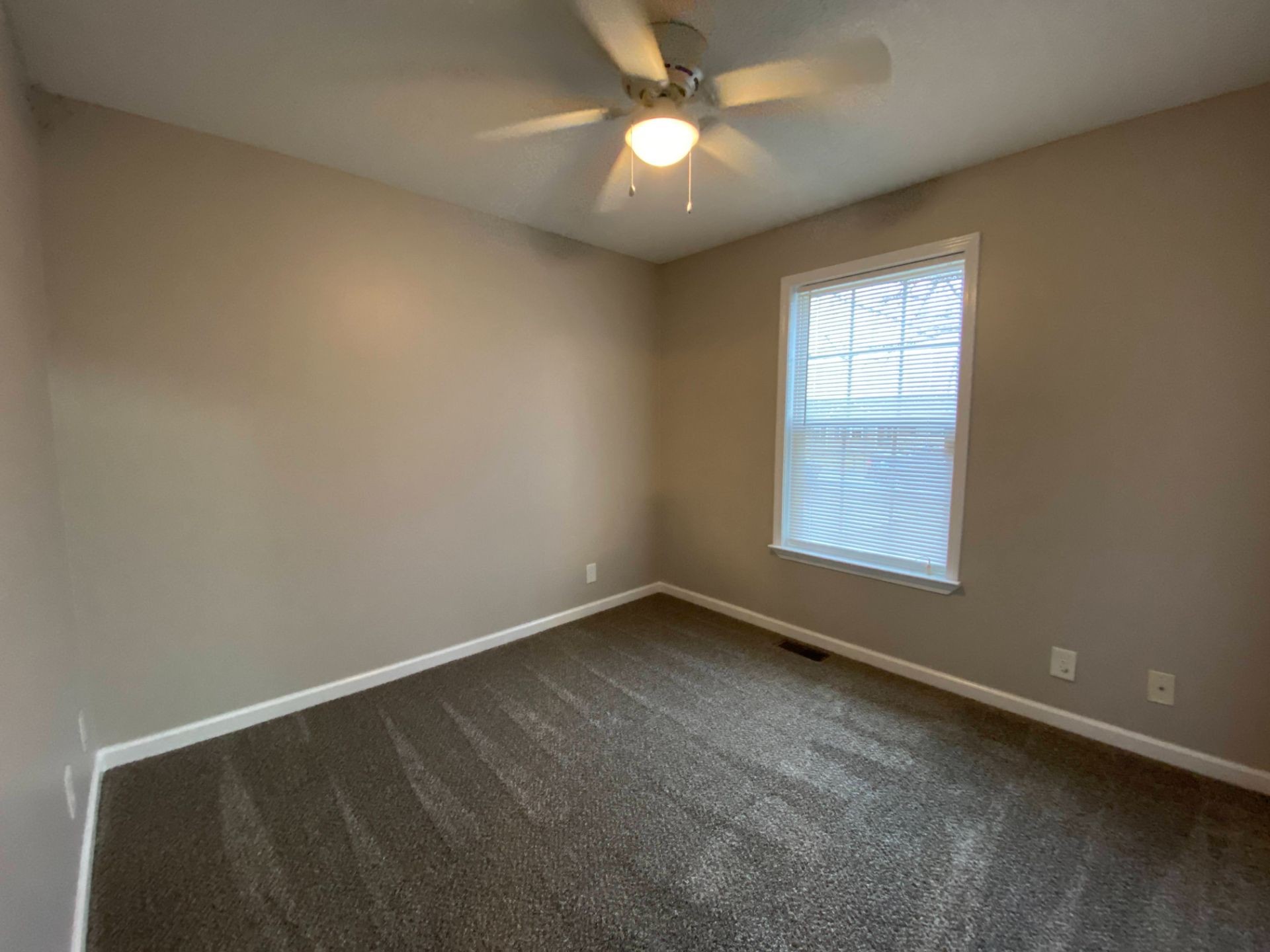428 Filmore Road Oak Grove, KY 42262 - Photo 13 of 16 an empty room with a window and a fan