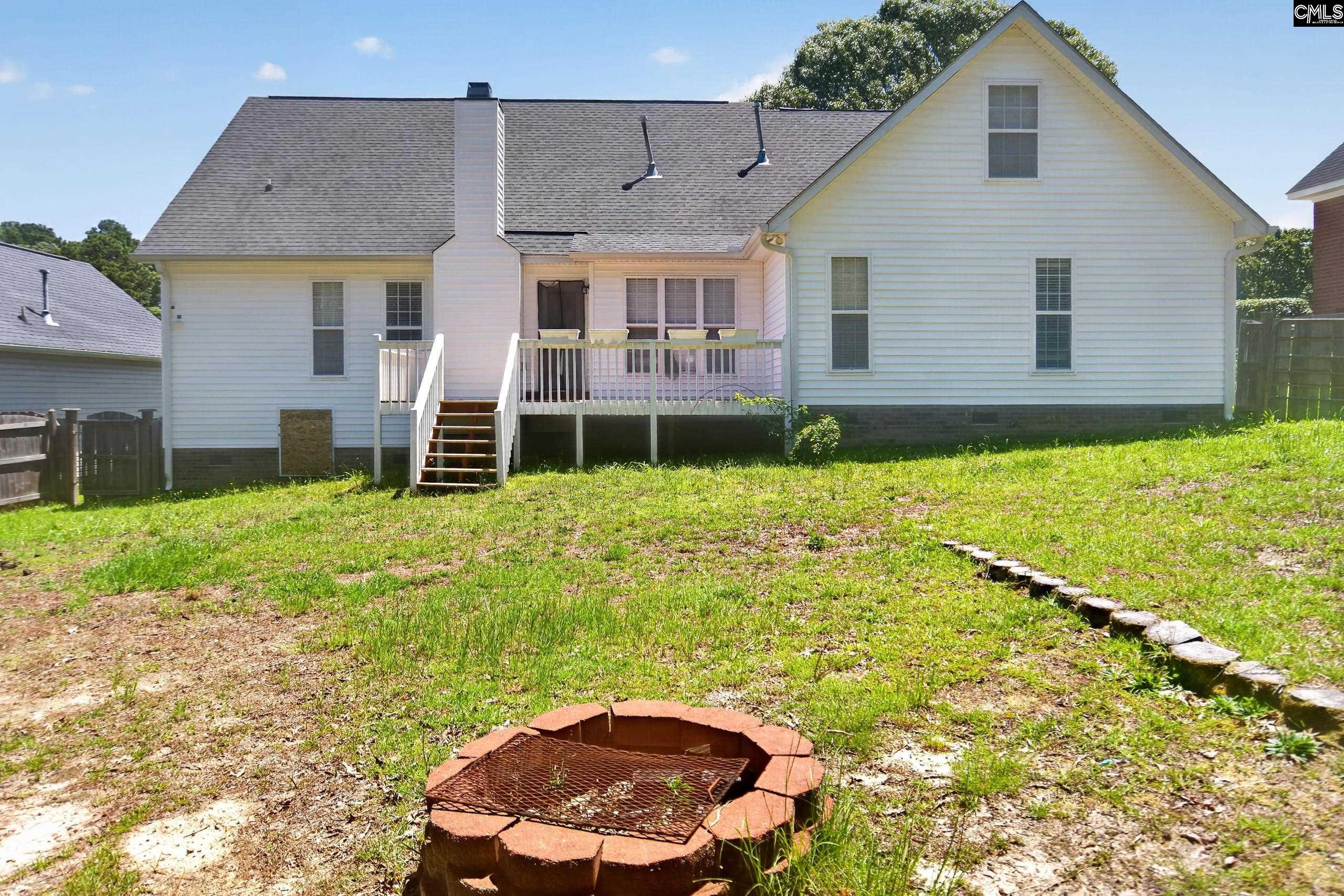 219 Plantation Pointe Drive Elgin, SC 29045 - Photo 47 of 56 a backyard of a house with table and chairs
