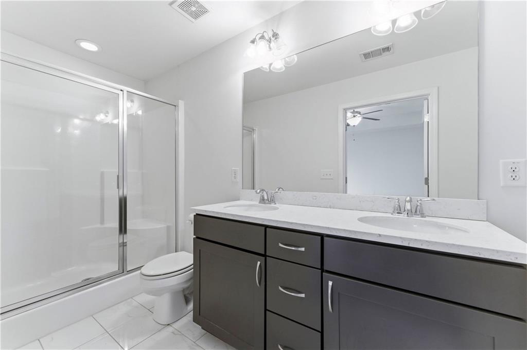 2717 Avanti Way Decatur, GA 30035 - Photo 14 of 15 a bathroom with a double vanity sink toilet and shower