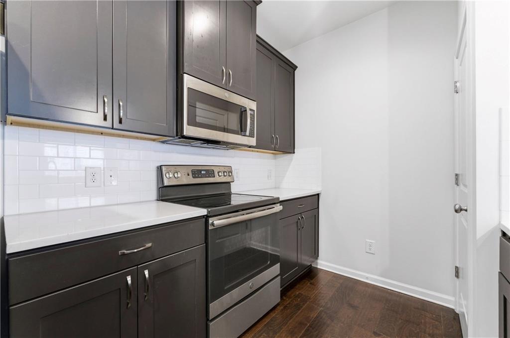 2717 Avanti Way Decatur, GA 30035 - Photo 3 of 15 a kitchen with stainless steel appliances granite countertop a stove microwave and sink