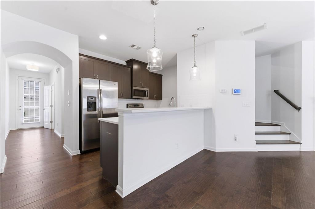 2717 Avanti Way Decatur, GA 30035 - Photo 4 of 15 a view of kitchen with refrigerator microwave and wooden floor