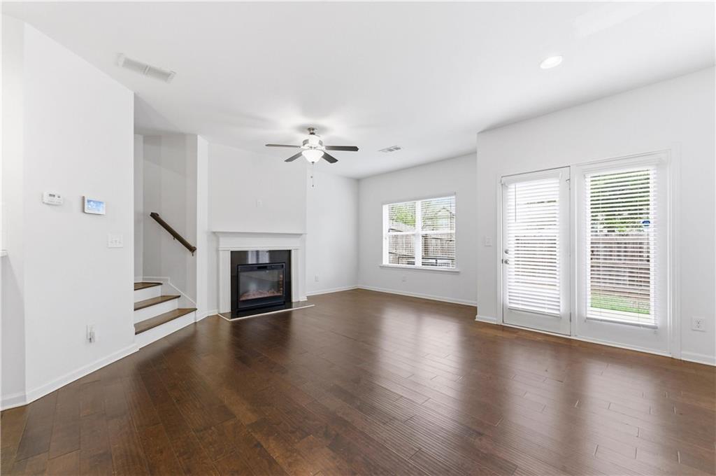 2717 Avanti Way Decatur, GA 30035 - Photo 5 of 15 an empty room with wooden floor fireplace and windows