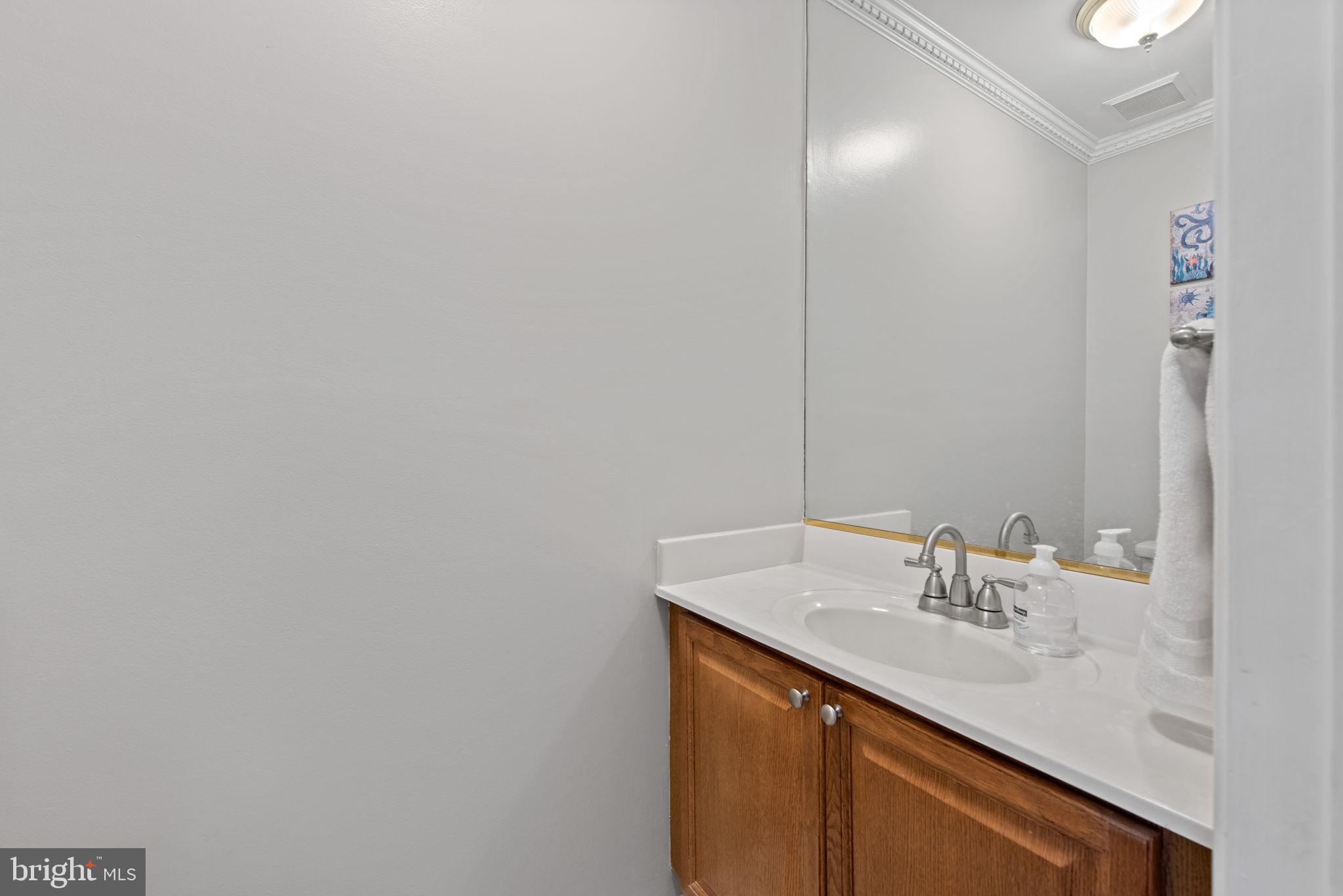8104 Creekview Drive Springfield, VA 22153 - Photo 15 of 39 a bathroom with a sink and a mirror