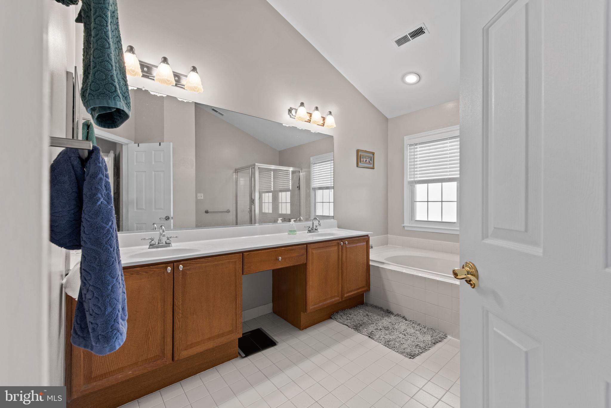 8104 Creekview Drive Springfield, VA 22153 - Photo 20 of 39 a large bathroom with a tub sink and mirror