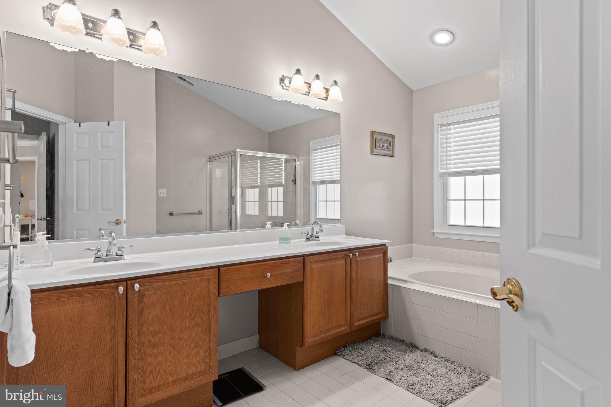 8104 Creekview Drive Springfield, VA 22153 - Photo 21 of 39 a bathroom with a tub sink and mirror