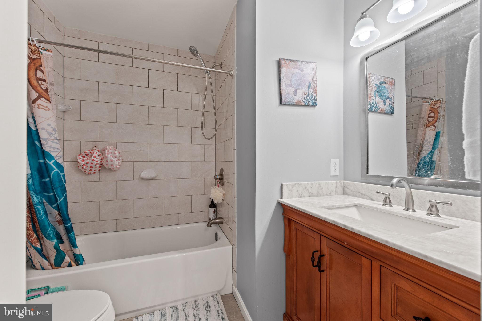 8104 Creekview Drive Springfield, VA 22153 - Photo 28 of 39 a bathroom with a sink a toilet and shower