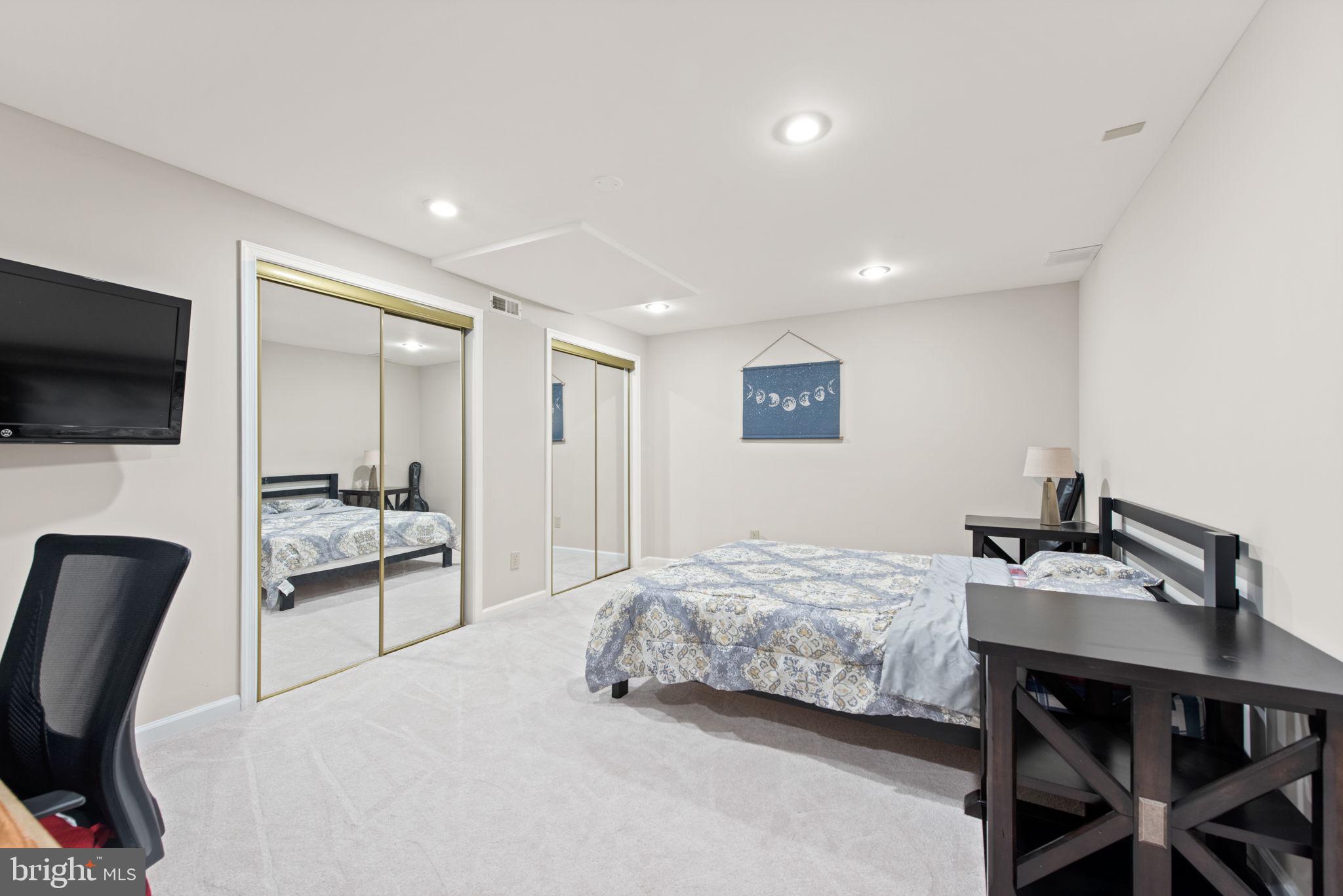 8104 Creekview Drive Springfield, VA 22153 - Photo 31 of 39 a bedroom with a bed and a flat screen tv