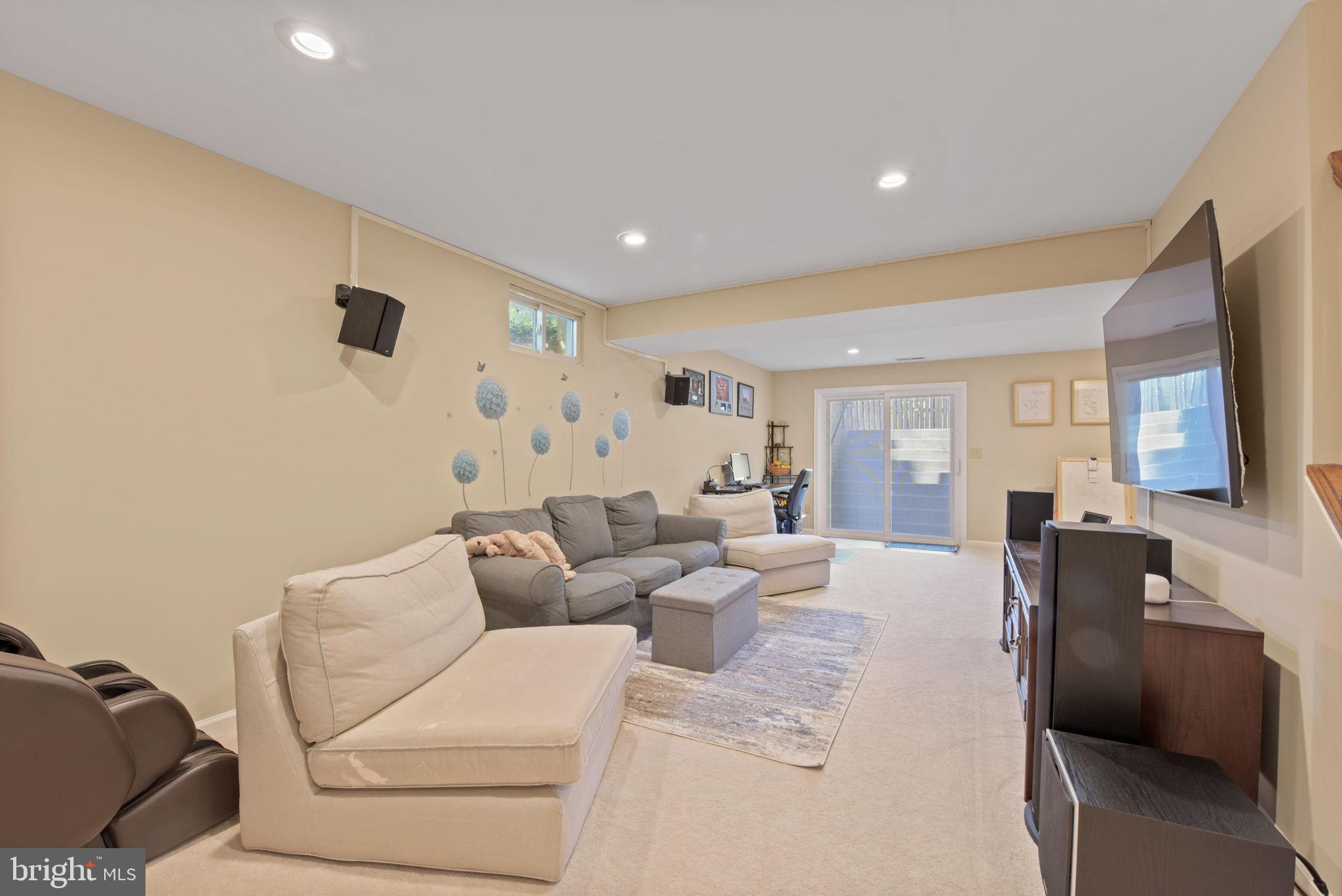 8104 Creekview Drive Springfield, VA 22153 - Photo 33 of 39 a living room with furniture and a flat screen tv
