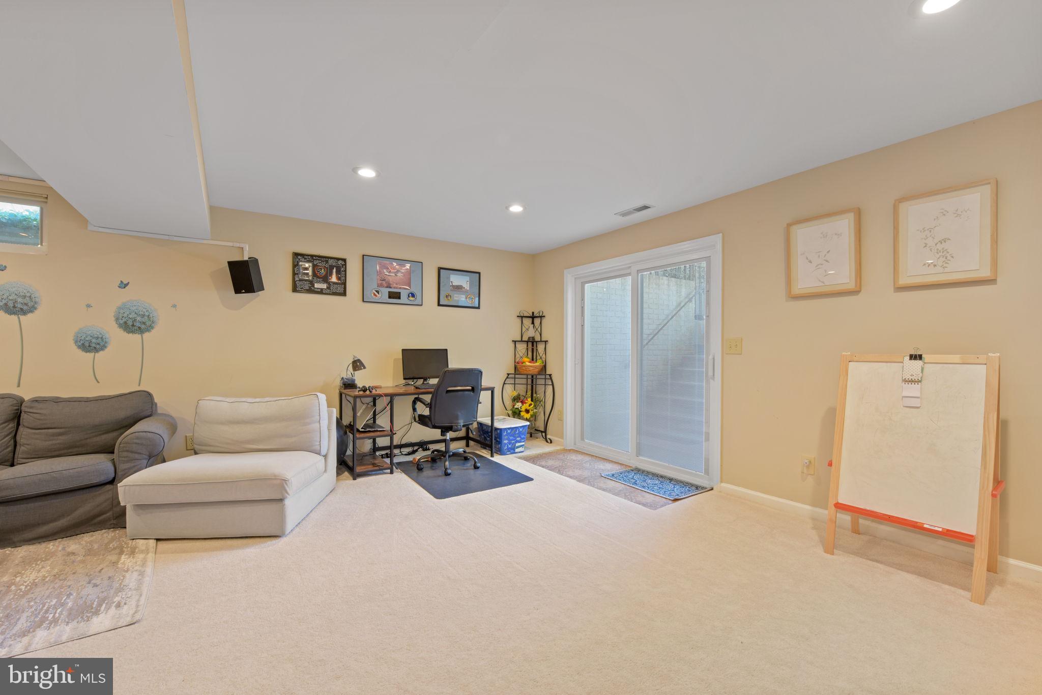 8104 Creekview Drive Springfield, VA 22153 - Photo 34 of 39 a living room with furniture a window and a flat screen tv