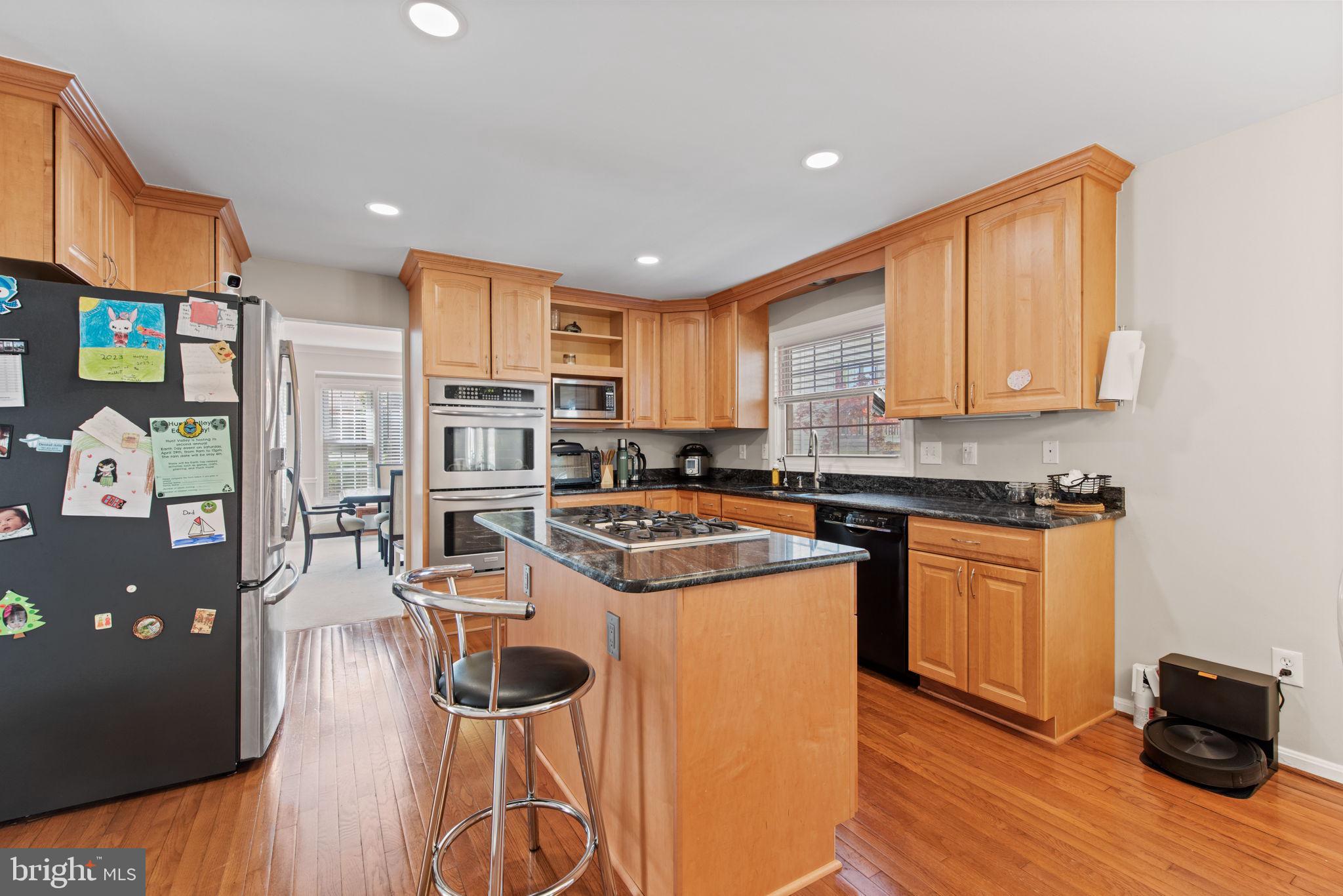 8104 Creekview Drive Springfield, VA 22153 - Photo 8 of 39 a kitchen with stainless steel appliances granite countertop a refrigerator a stove top oven and a sink