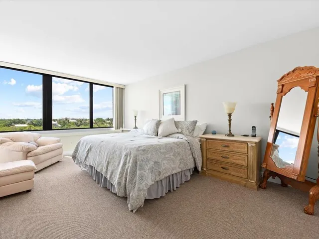 a spacious bedroom with a bed and a couch