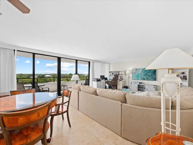 a living room with furniture and a floor to ceiling window