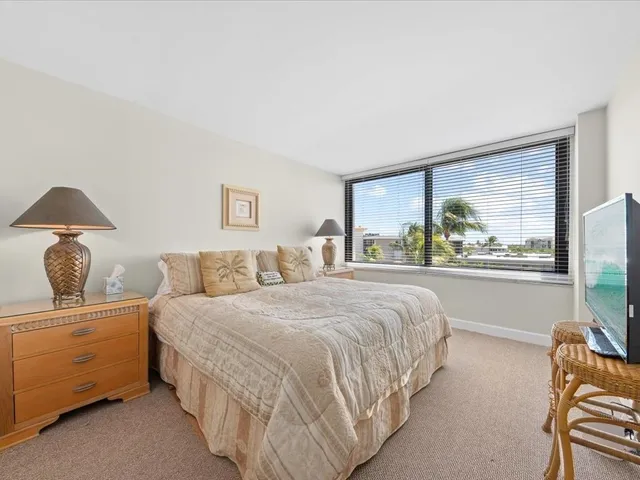 a bedroom with a bed and lamp