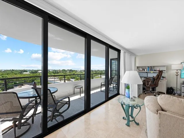a living room with furniture and a floor to ceiling window