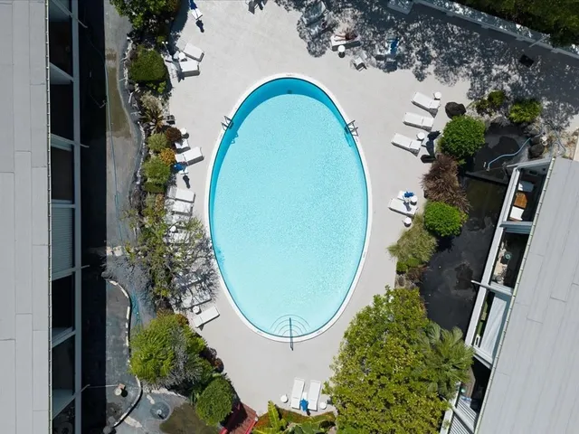 an aerial view of multiple houses with yard