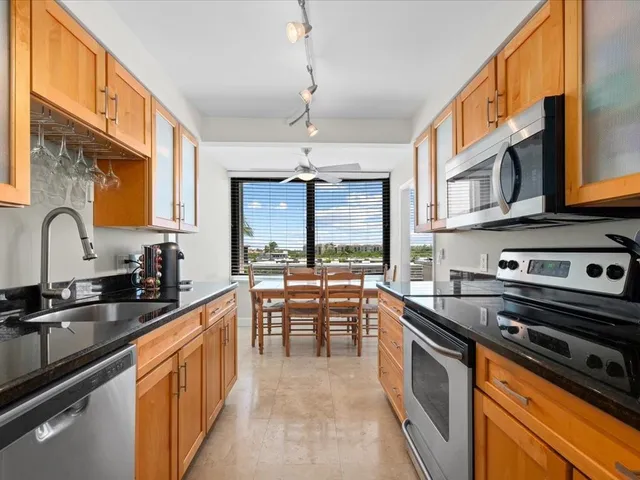 a kitchen with stainless steel appliances a sink stove and cabinets