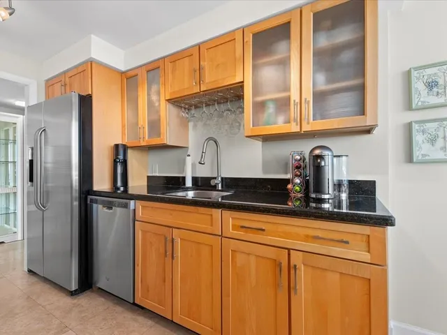 a kitchen with stainless steel appliances granite countertop a stove and a microwave
