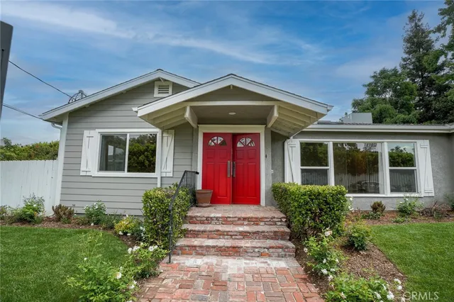 a front view of a house with garden
