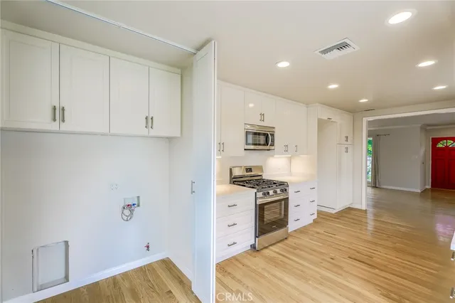 a kitchen with stainless steel appliances granite countertop a stove and a refrigerator