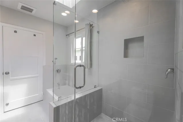 a bathroom with a shower and a sink