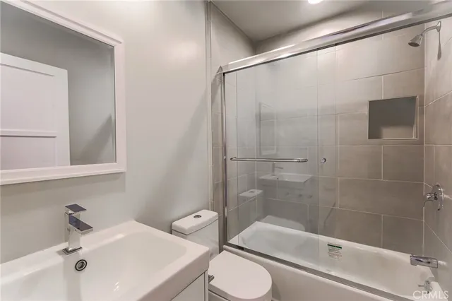 a bathroom with a sink mirror bathtub and toilet